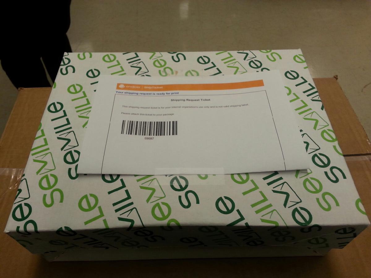 An example of a smaller package with ship ticket folded in half with barcode side up, affixed to shipment with two small pieces of tape.