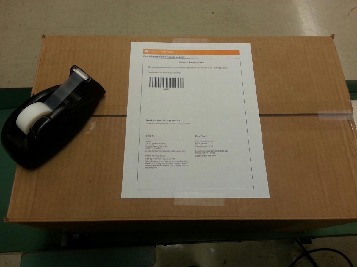 Image of package with example ship ticket affixed with two small pieces of tape.